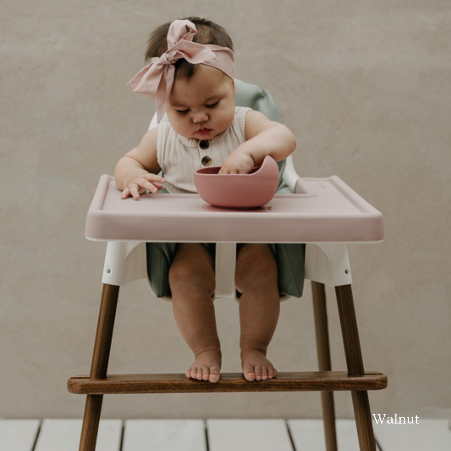 IKEA Antilop highchair fitted with a footrest supporting baby's feet