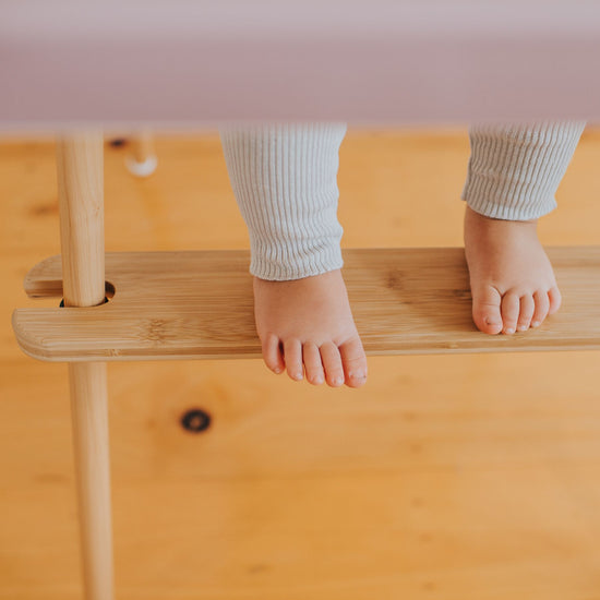 Childs feet on IKEA highchair footrest in bamboo