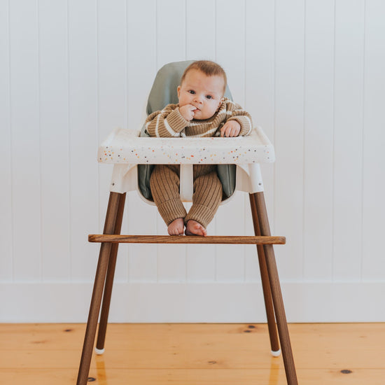 IKEA Highchair Foot Rest in Walnut with Confetti Placemat