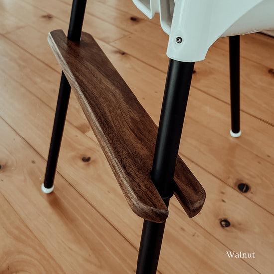 Highchair footrest in walnut timber with matte black leg wraps