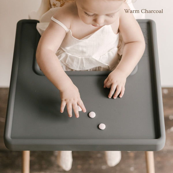 Overhead view of Little Puku IKEA Antilop placemat with food showing spill containment and wipe-clean surface